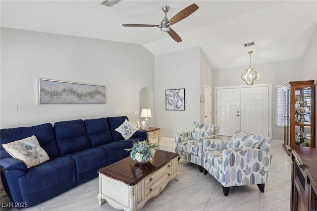 living room featuring ceiling fan and lofted ceiling