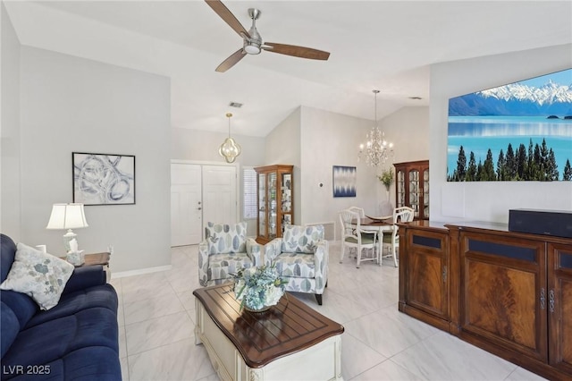 living room with ceiling fan with notable chandelier and vaulted ceiling