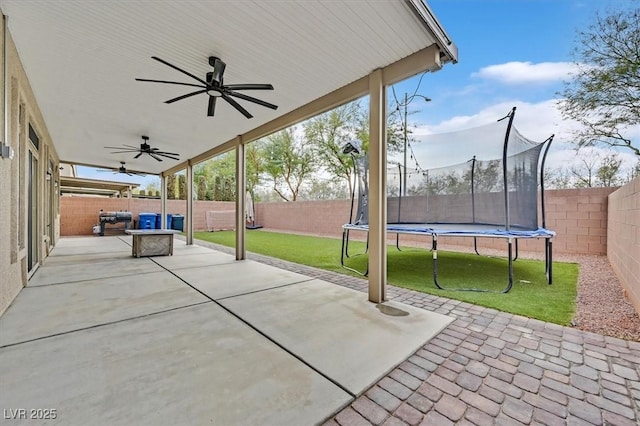 view of patio with ceiling fan, an outdoor hangout area, and a trampoline