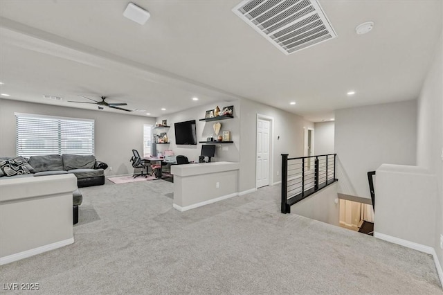 carpeted living room with ceiling fan