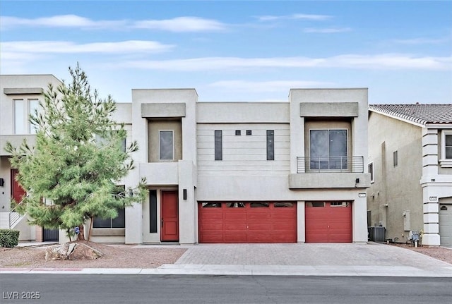 modern home featuring a garage and central AC unit