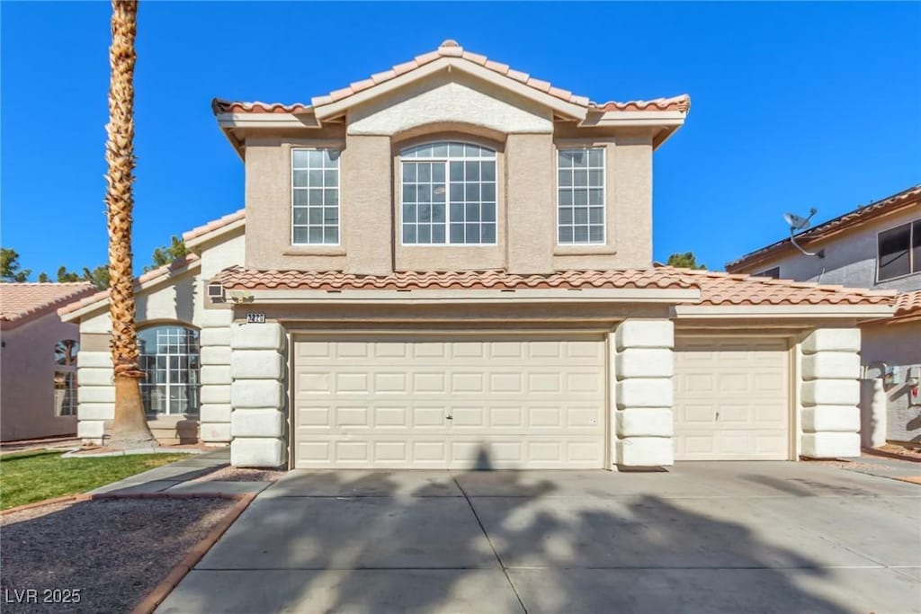 mediterranean / spanish-style home featuring a garage