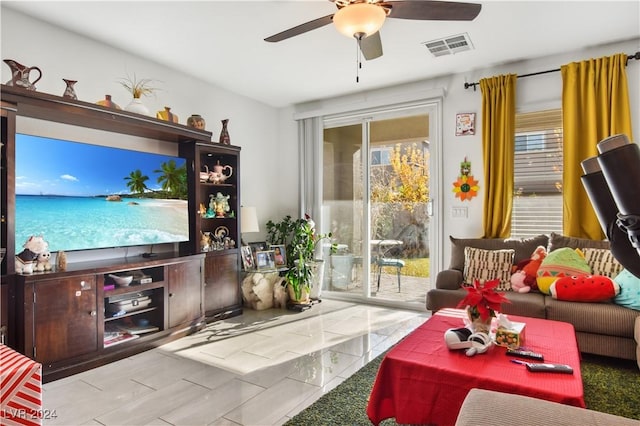 tiled living room with ceiling fan