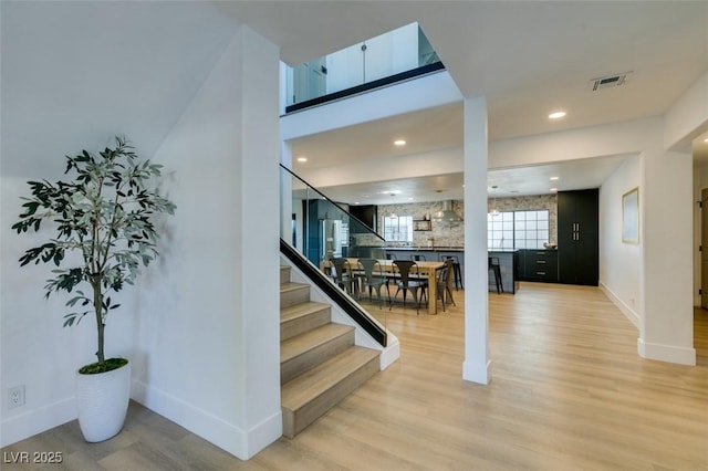 stairway with hardwood / wood-style flooring