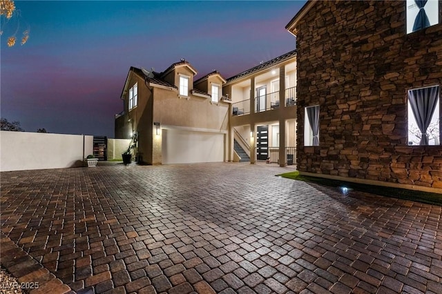 view of front of property with a balcony and a garage