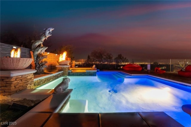 pool at dusk featuring an outdoor fire pit