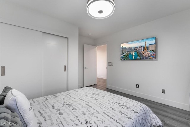 bedroom featuring dark hardwood / wood-style floors and a closet