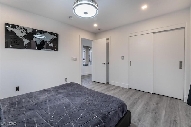 bedroom featuring hardwood / wood-style flooring and a closet