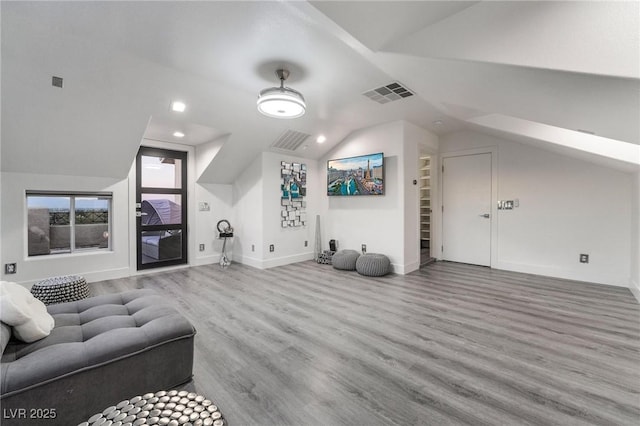 additional living space featuring hardwood / wood-style flooring and vaulted ceiling