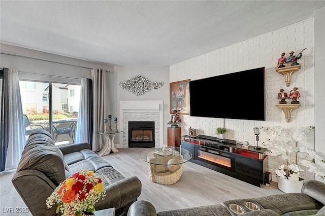 living room with light hardwood / wood-style flooring and a textured ceiling