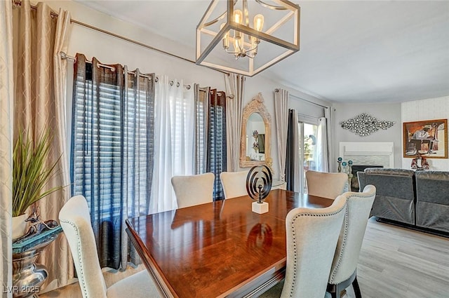 dining area featuring a notable chandelier and light wood-type flooring