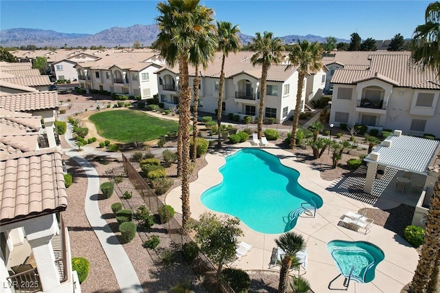 view of swimming pool featuring a patio and a mountain view