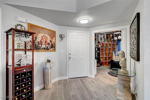 foyer entrance featuring hardwood / wood-style flooring and a textured ceiling