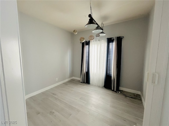 unfurnished room with light hardwood / wood-style floors