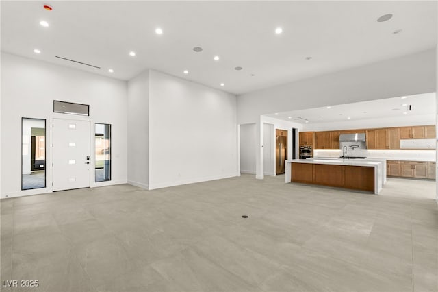 unfurnished living room with a high ceiling