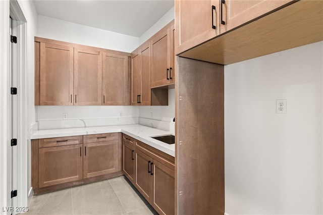 kitchen featuring light stone counters and light tile patterned floors