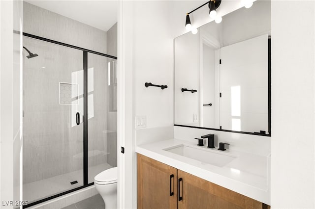 bathroom with vanity, toilet, and walk in shower