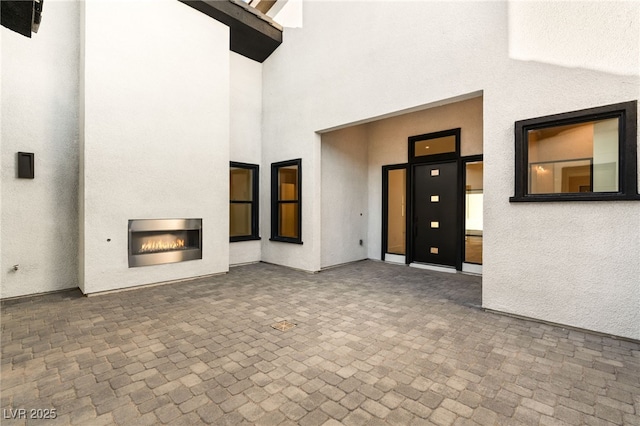 interior space featuring heating unit and an outdoor fireplace