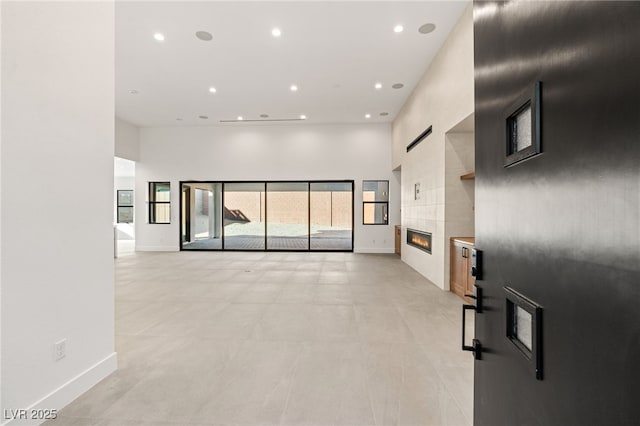 spare room with a fireplace and a high ceiling