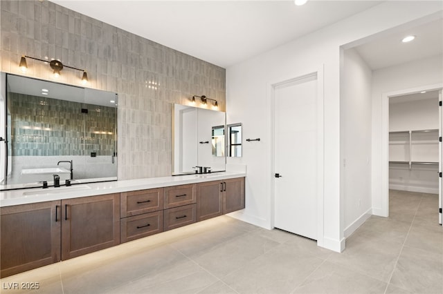 bathroom with tile patterned flooring, vanity, and tile walls