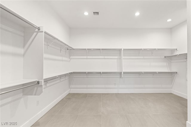 walk in closet featuring light tile patterned flooring