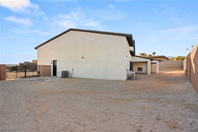 rear view of house featuring central AC unit