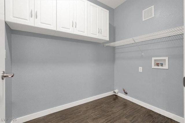 laundry area with cabinets, dark wood-type flooring, washer hookup, and hookup for a gas dryer