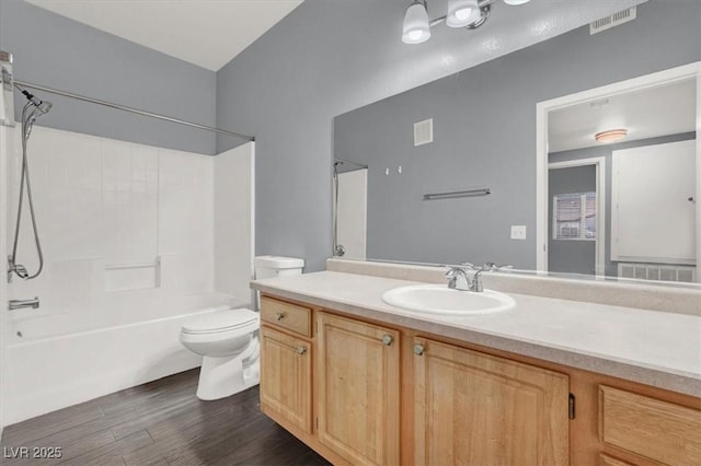 full bathroom featuring shower / bathing tub combination, hardwood / wood-style flooring, vanity, and toilet