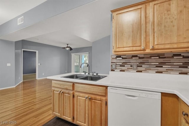 kitchen featuring white dishwasher, light brown cabinets, sink, and hardwood / wood-style flooring