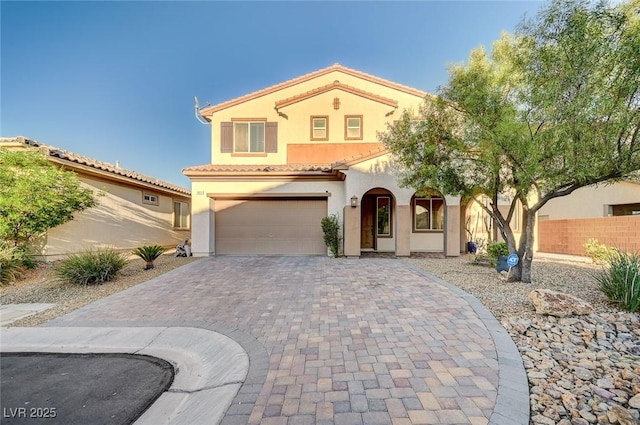 mediterranean / spanish-style home with a garage