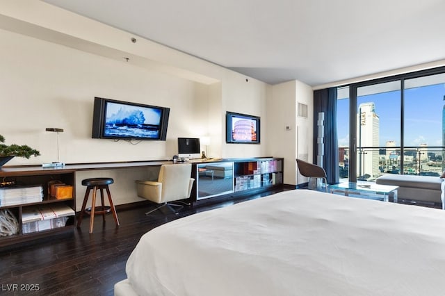 bedroom featuring dark hardwood / wood-style floors, floor to ceiling windows, and multiple windows