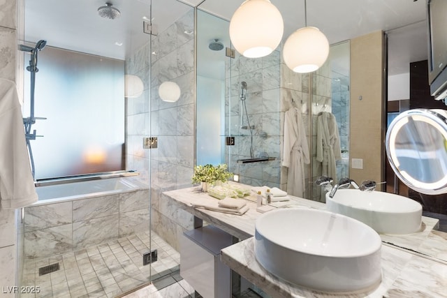 bathroom with vanity, a shower with door, and tile walls