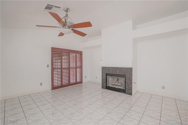 unfurnished living room featuring ceiling fan and a premium fireplace