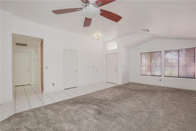 carpeted spare room featuring ceiling fan and lofted ceiling