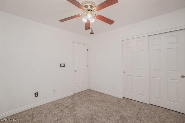 unfurnished bedroom featuring ceiling fan, light carpet, and a closet