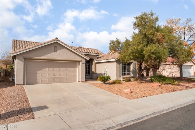 mediterranean / spanish-style home with a garage