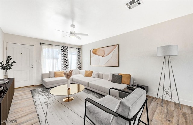 living room featuring ceiling fan and light hardwood / wood-style floors