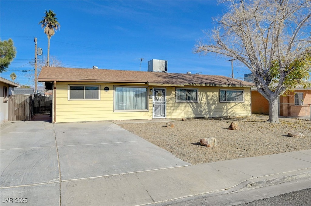 single story home featuring fence