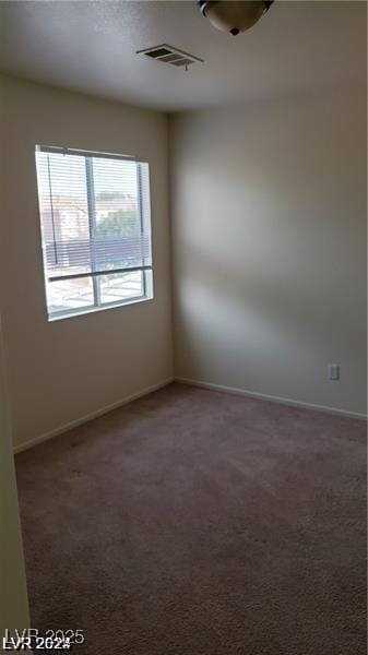 empty room featuring dark colored carpet