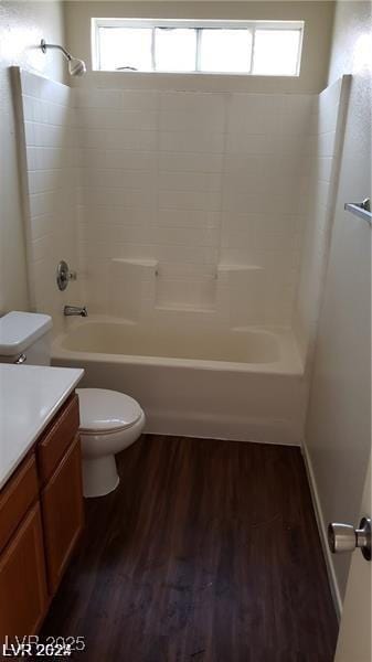 full bathroom with hardwood / wood-style flooring, toilet, vanity, and tub / shower combination