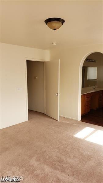 carpeted empty room featuring sink