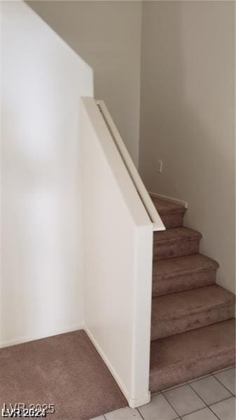 stairway featuring tile patterned flooring