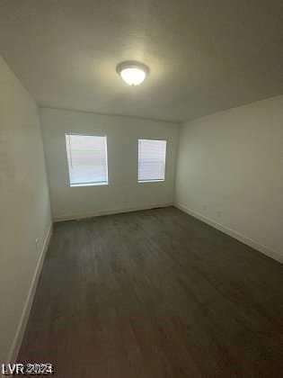 unfurnished room featuring dark hardwood / wood-style floors