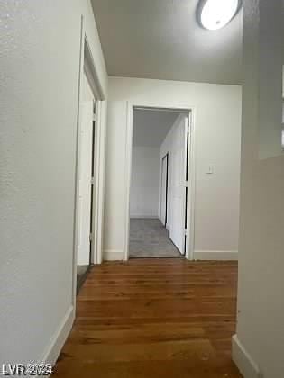 hall with dark hardwood / wood-style flooring