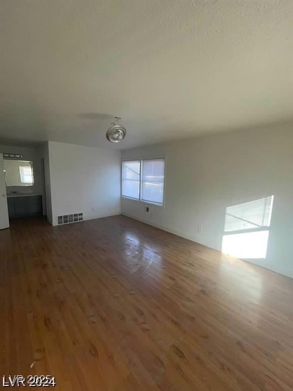 unfurnished living room with dark hardwood / wood-style floors