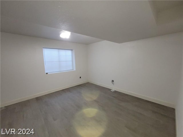 spare room with dark hardwood / wood-style flooring