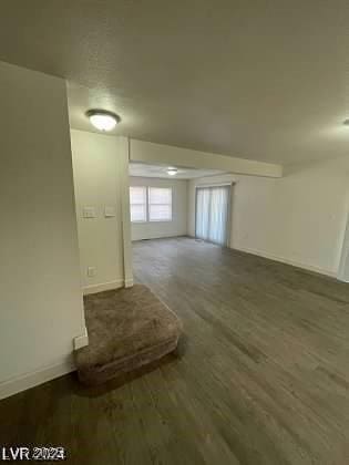 empty room with dark wood-type flooring