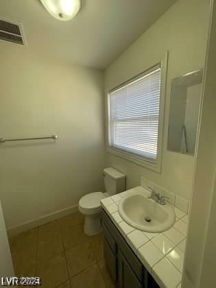 bathroom with tile patterned floors, vanity, and toilet