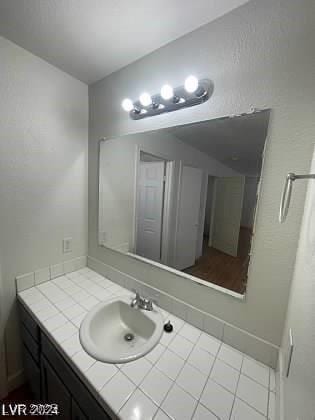 bathroom featuring tile patterned flooring and vanity