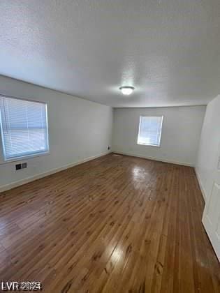 interior space featuring a textured ceiling and dark hardwood / wood-style floors